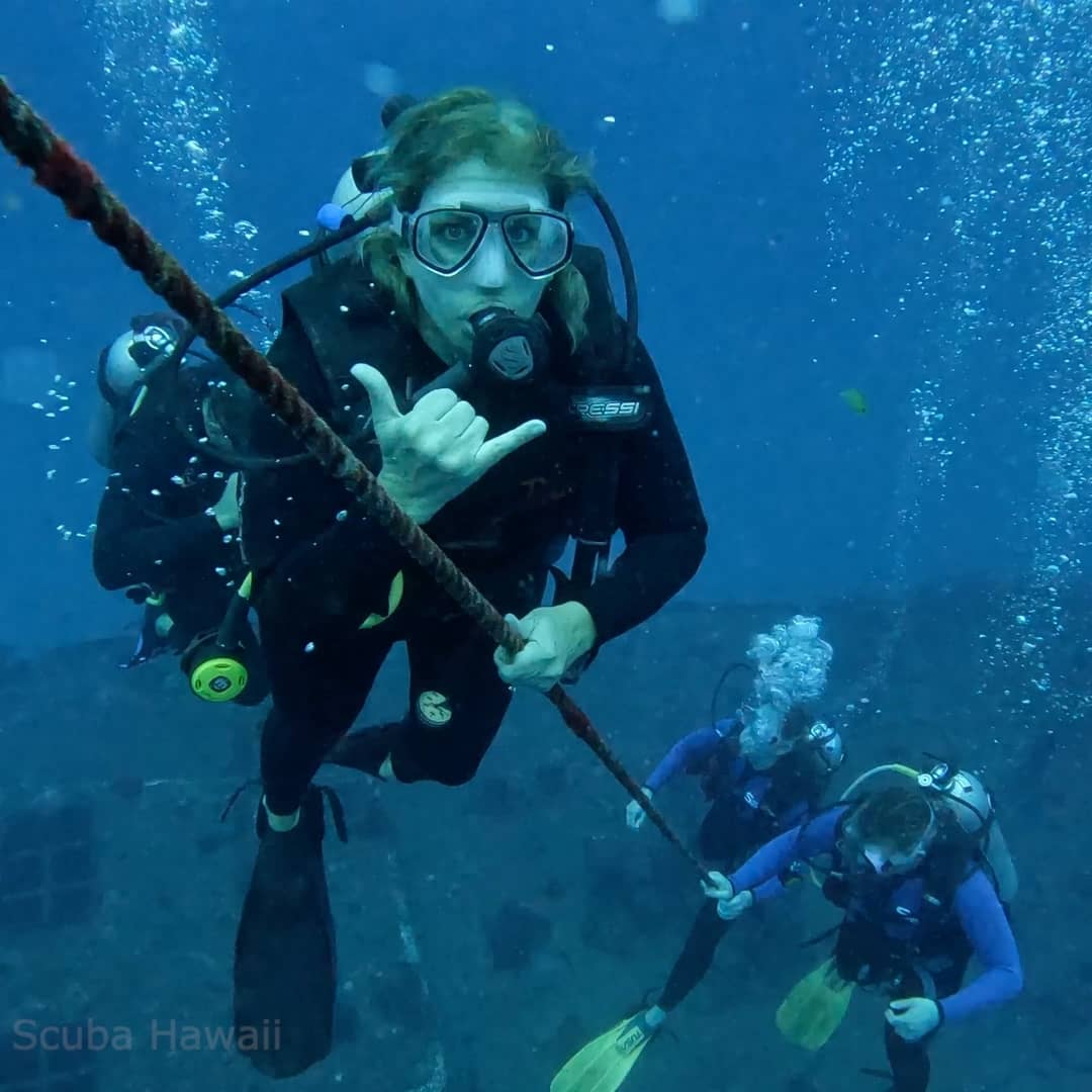 Divers ascending mooring line on Sea Tiger